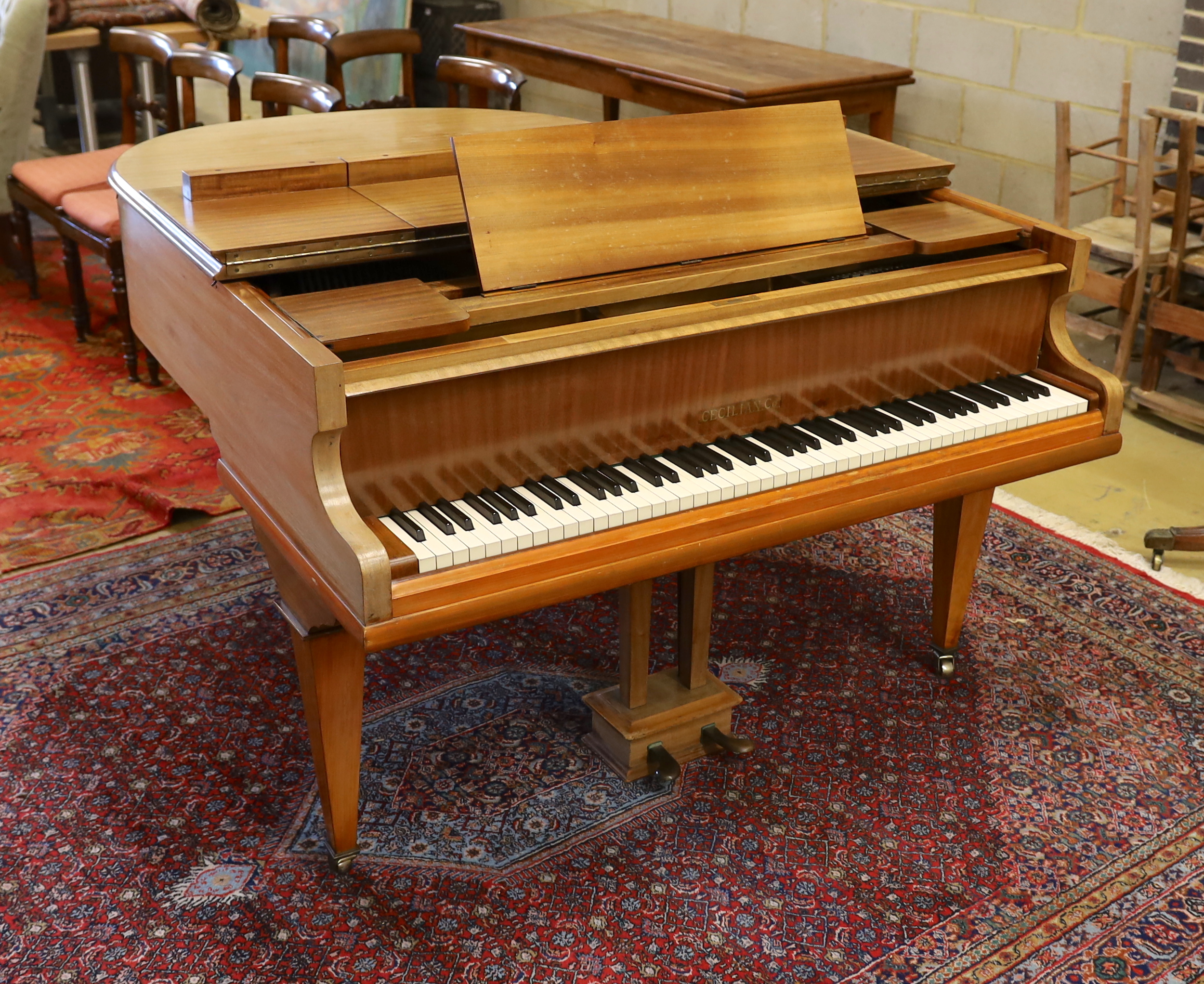 A mid 20th Cecilian & Co mahogany baby grand piano retailed by Harrods Ltd